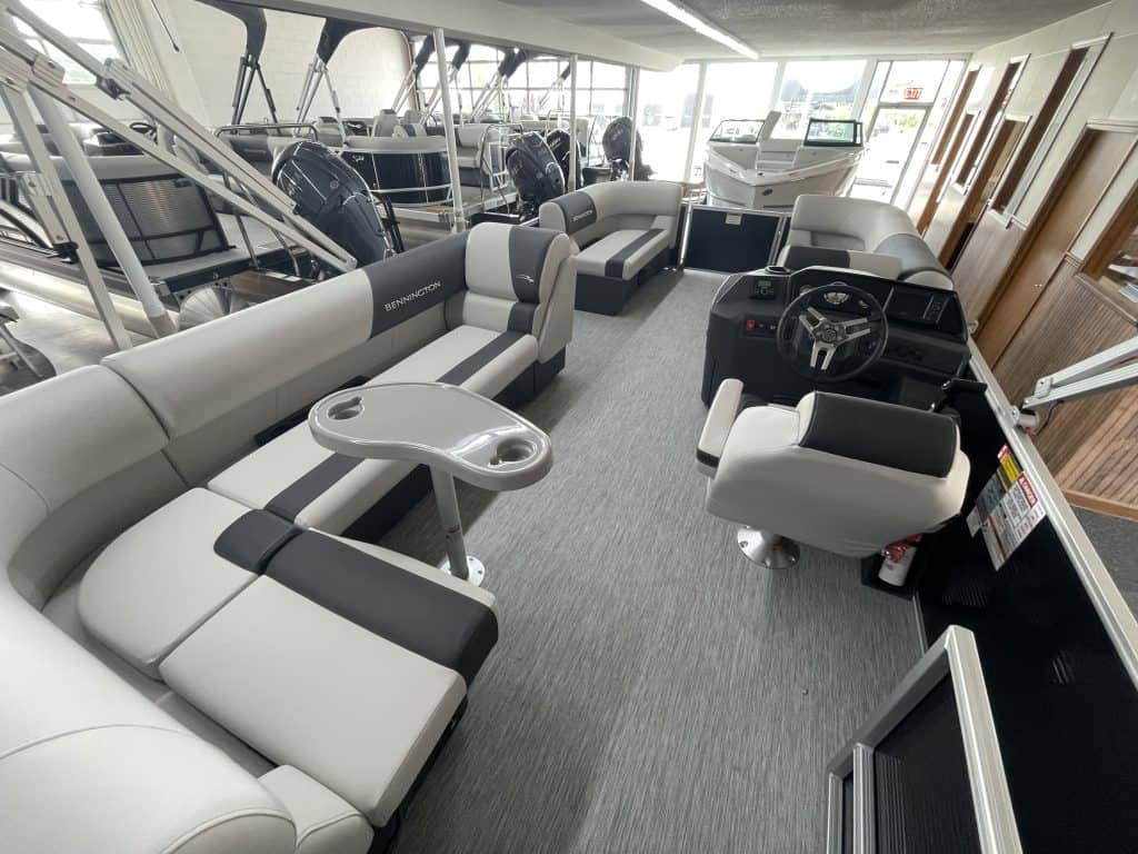 Indoor boat showroom with various boats and seating areas at Hall's Sport Center.