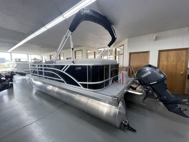 Pontoon boat with Yamaha outboard motor inside Hall's Sport Center.