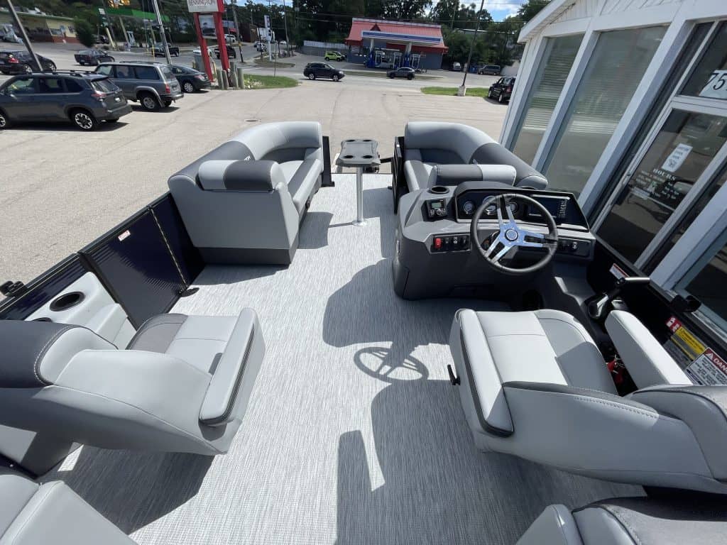 View of the cockpit and seating area of a Bennington 22S1 SSR pontoon boat.
