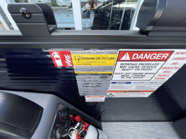 Boat safety labels including fire extinguisher capacity and danger warnings.
