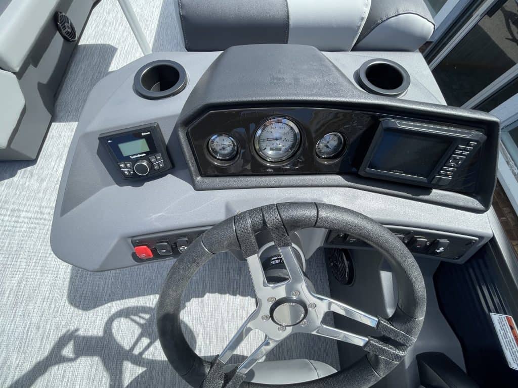 Boat dashboard with gauges and navigation system in Bennington 22S1 SSR.