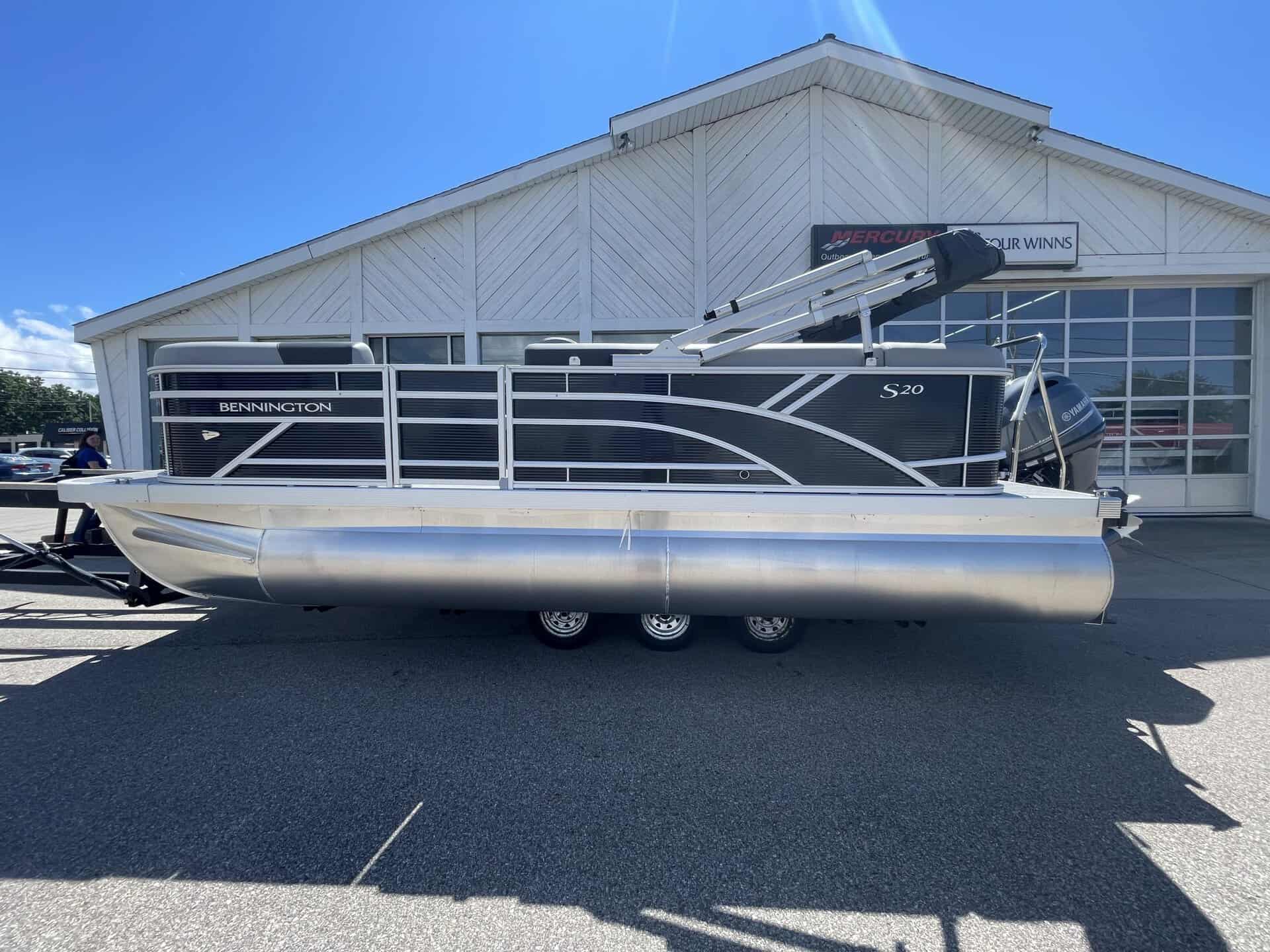 Bennington 20S1 SL pontoon boat parked outside Hall's Sport Center.