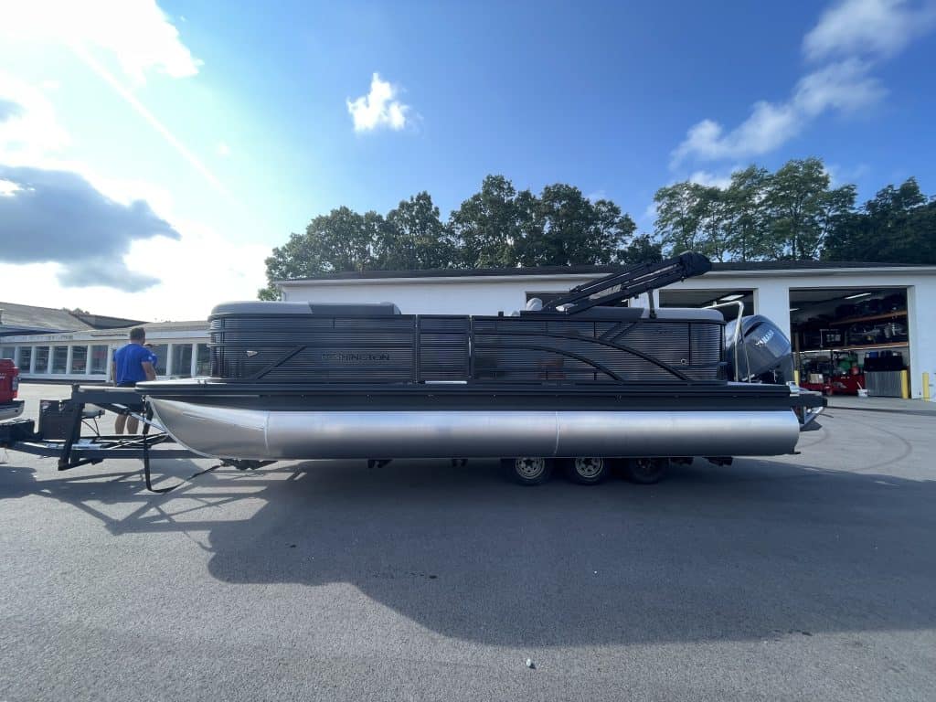 Bennington 22S1 SSR pontoon boat parked outside a service center.