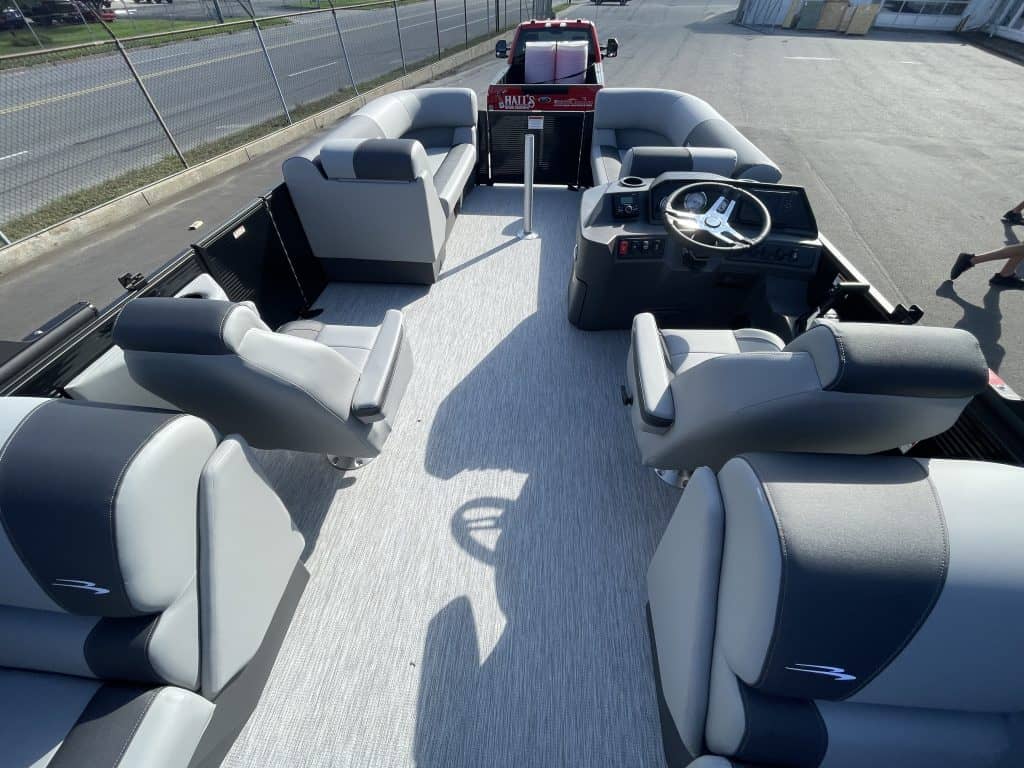Luxury Bennington 22S1 SSR pontoon boat with spacious seating and steering console.