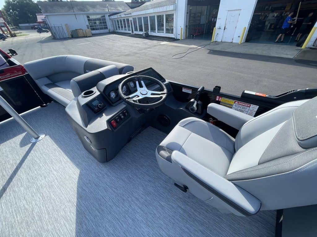 Boat helm with steering wheel and controls at Hall's Sport Center.