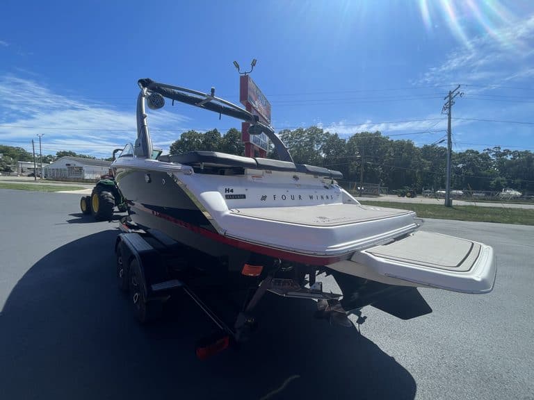 Luxury Four Winns H4 boat on trailer at Hall's Sport Center.
