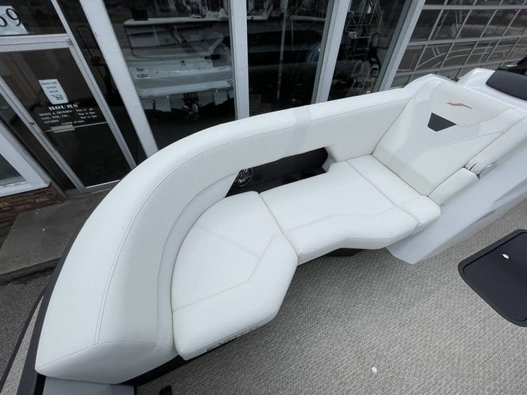 Modern white lounge chair with curved design at Hall's Sport Center.