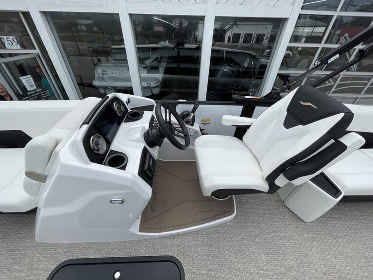 Luxury boat interior with white seating and dashboard.