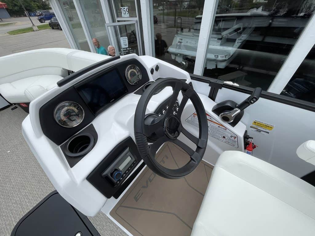 Boat dashboard with steering wheel and controls at Hall's Sport Center.