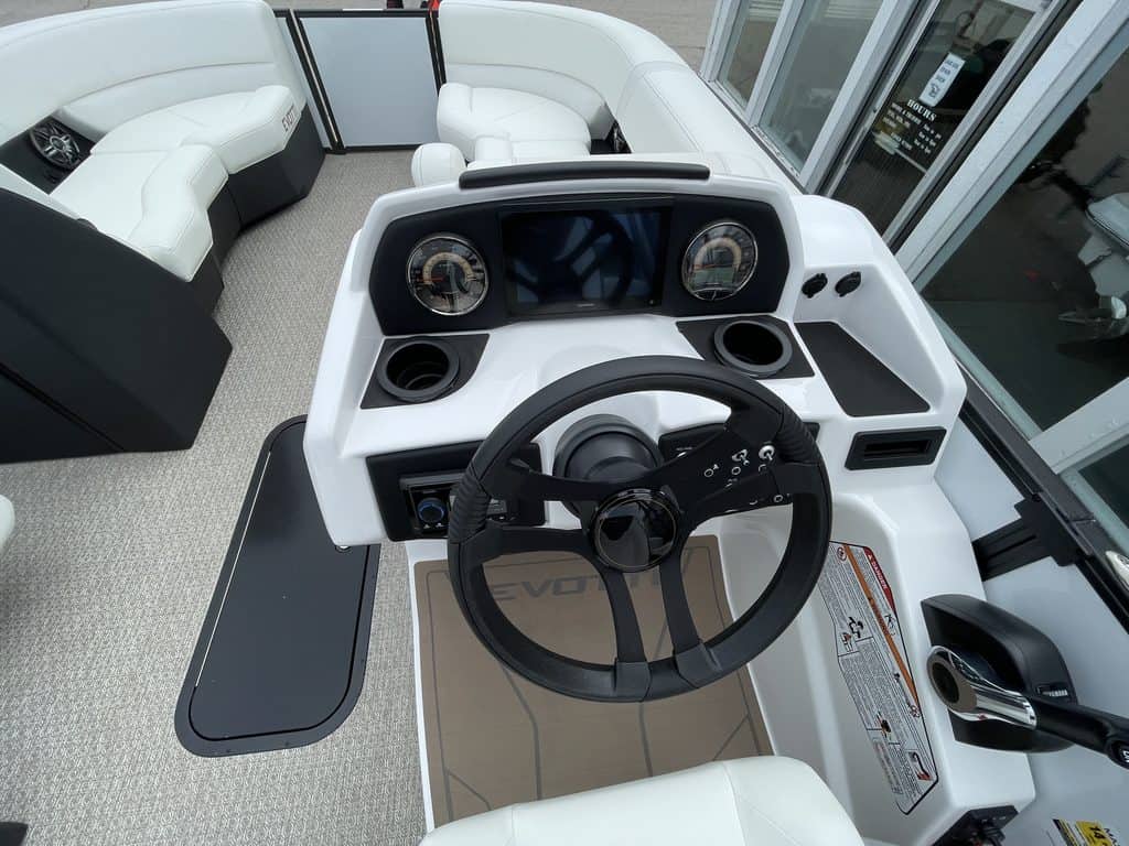 Boat console with steering wheel and gauges at Hall's Sport Center.