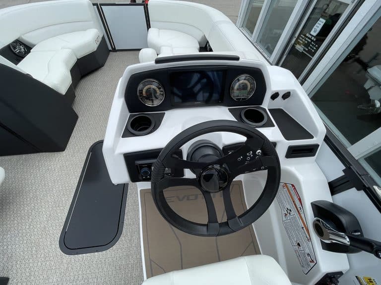 Boat console with steering wheel and gauges at Hall's Sport Center.