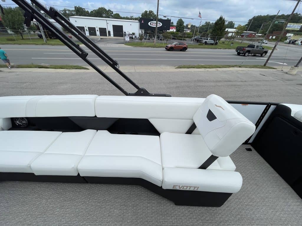 Luxury white pontoon boat interior with seating and steering console.