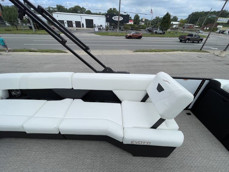 Luxury white pontoon boat interior with seating and steering console.