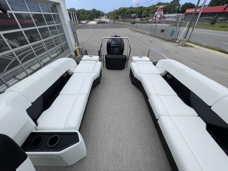 White pontoon boat with seating and steering console at Hall's Sport Center.