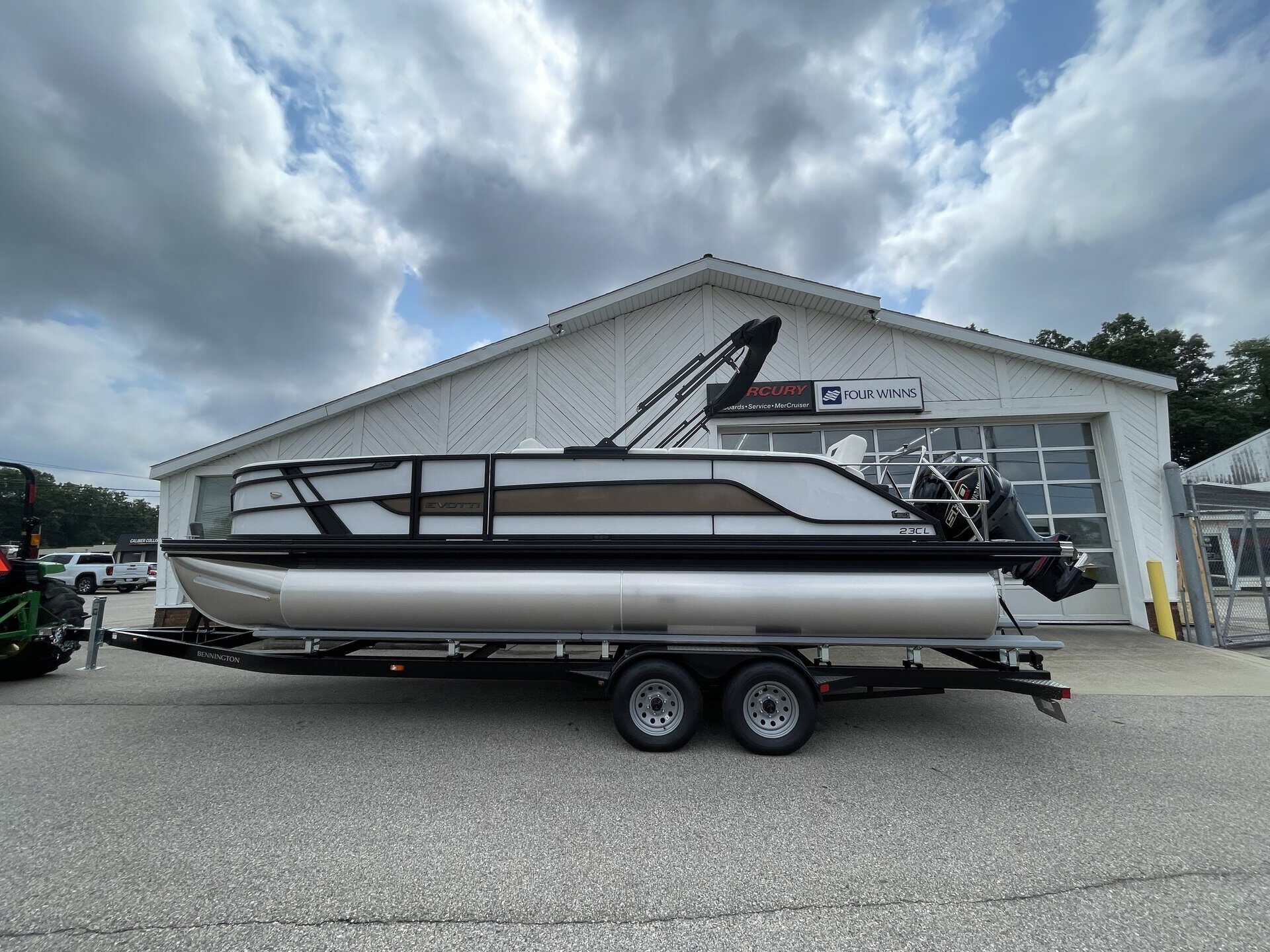 Luxury pontoon boat on trailer outside Hall's Sport Center in Georgia.