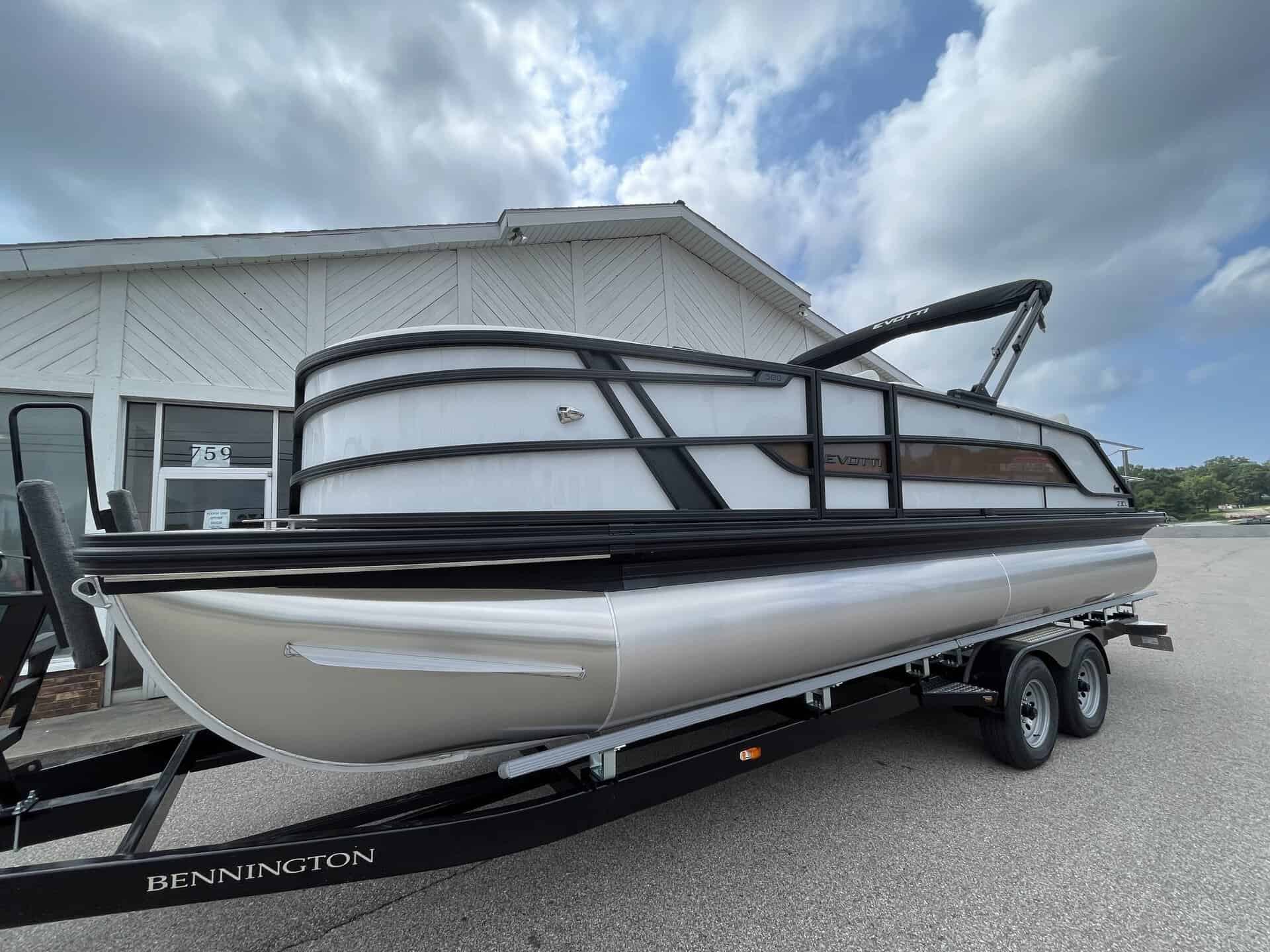 Bennington pontoon boat on trailer at Hall's Sport Center for sale or rent.