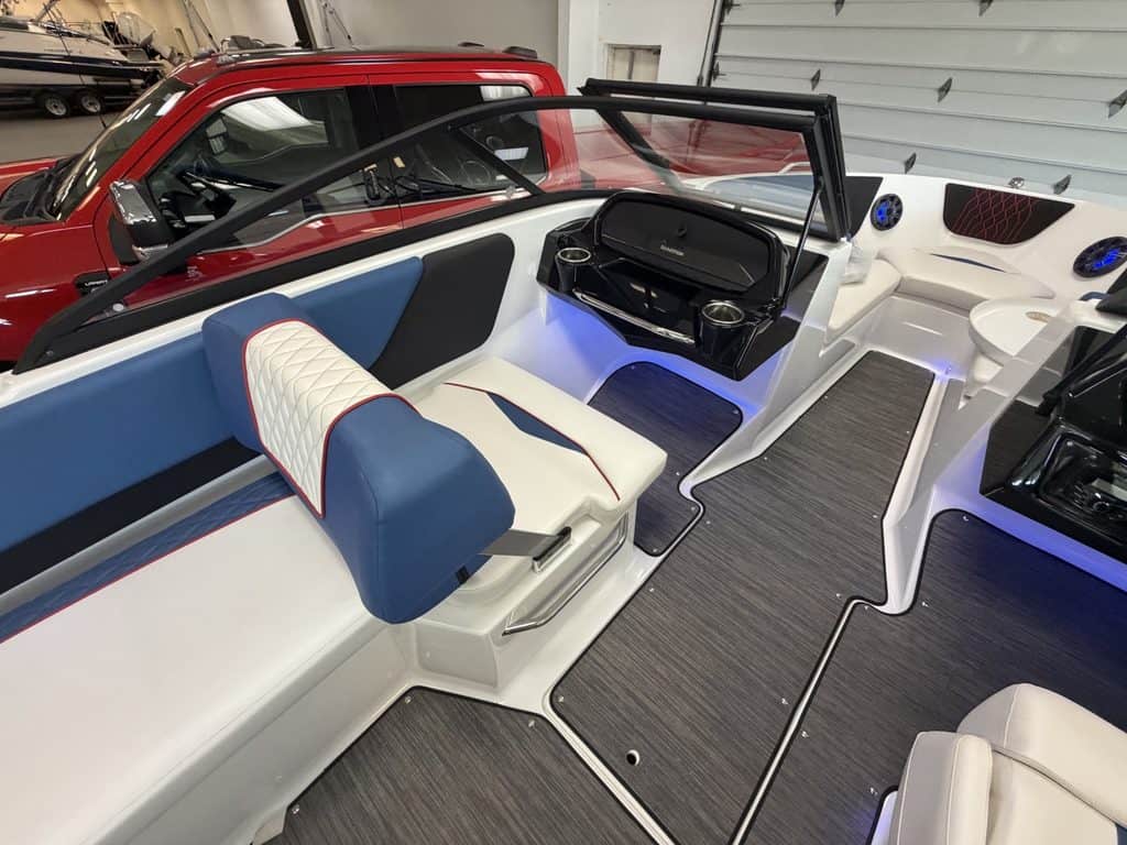 Interior view of the 2021 Glastron GX215 boat with seating and steering wheel.