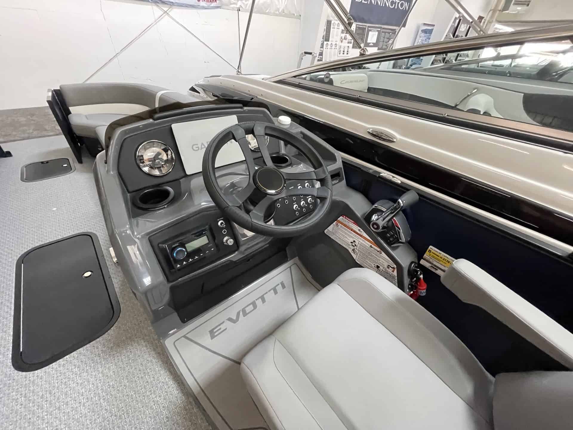 Close-up of the helm station in the 2027 EVOTTI 525QL boat.