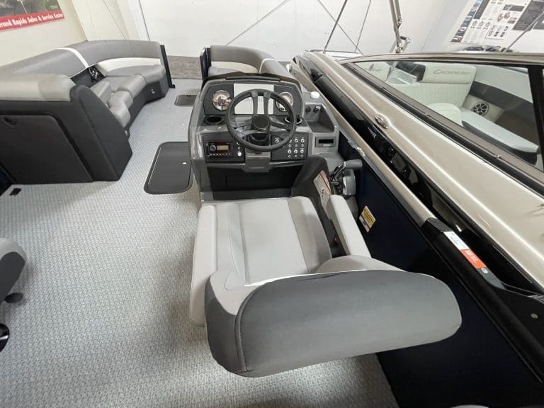 Pontoon boat helm with steering wheel and seating at Hall's Sport Center.