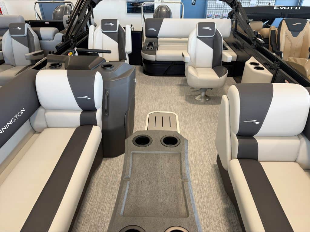 Interior view of a Bennington 22 S1SB pontoon boat with seating and cup holders.