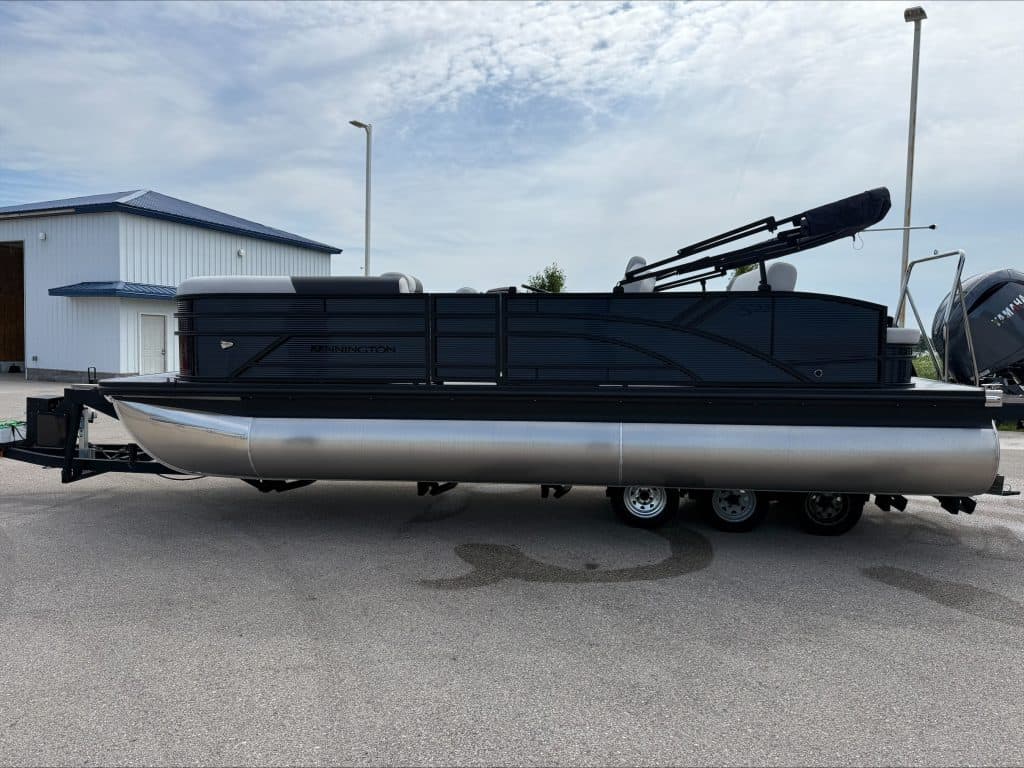 Bennington 22 S1SB pontoon boat with outboard motor on trailer.