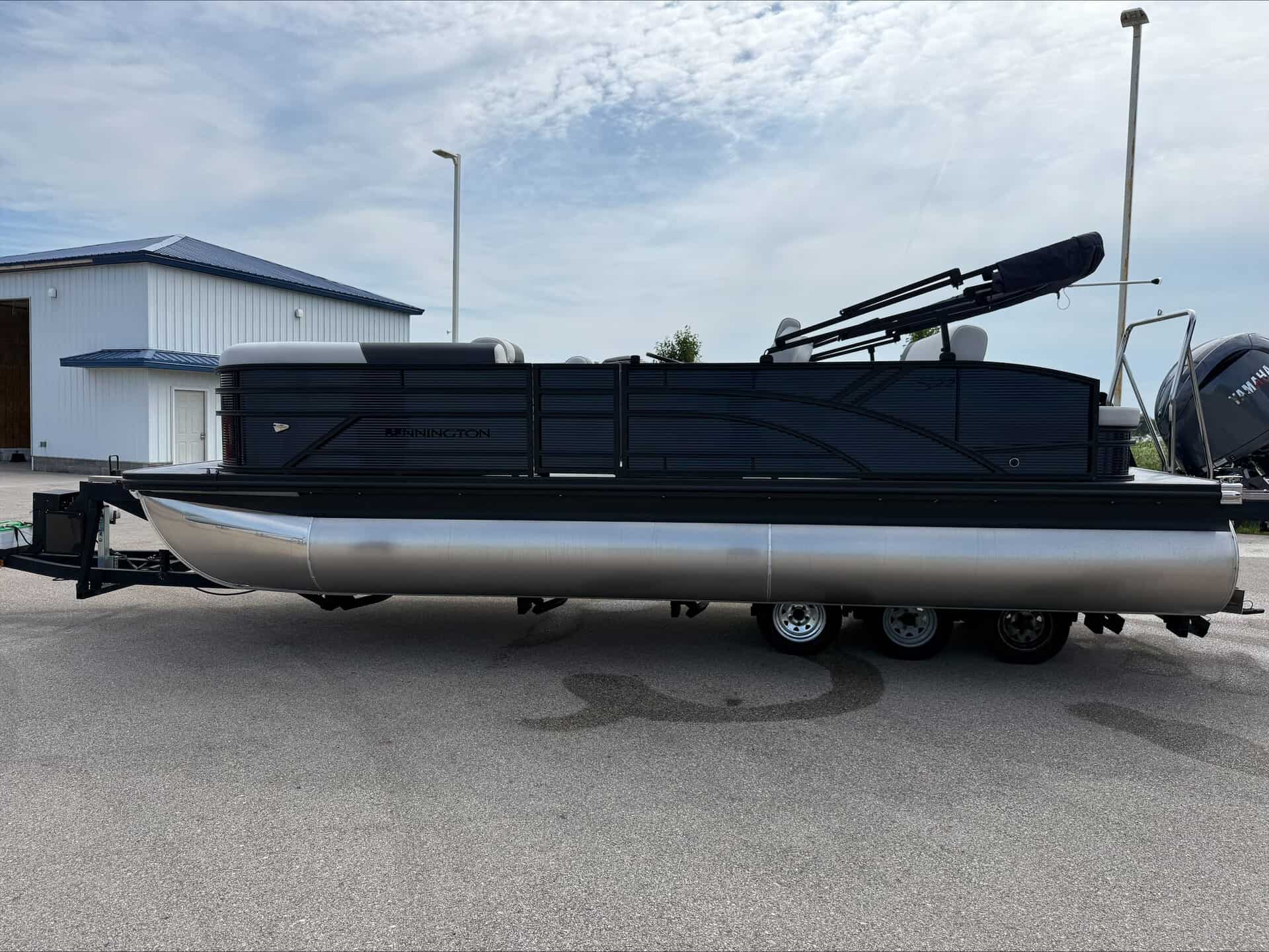 Bennington 22 S1SB pontoon boat with outboard motor on trailer.
