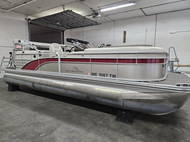 Bennington 2250 GPD pontoon boat in indoor storage.