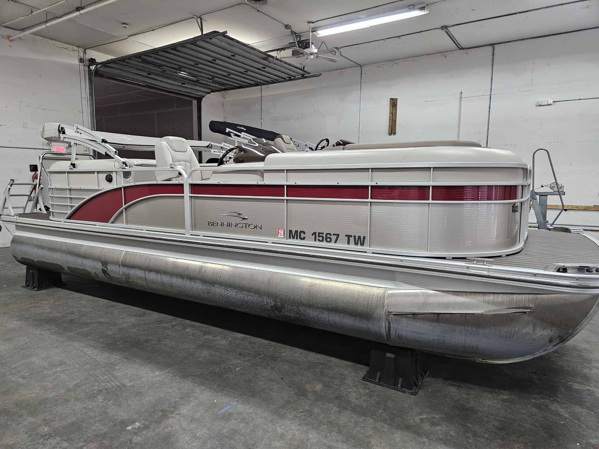 Bennington 2250 GPD pontoon boat in indoor storage.