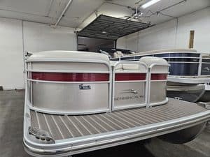 Bennington 2250 GPD pontoon boat in showroom at Hall's Sport Center.