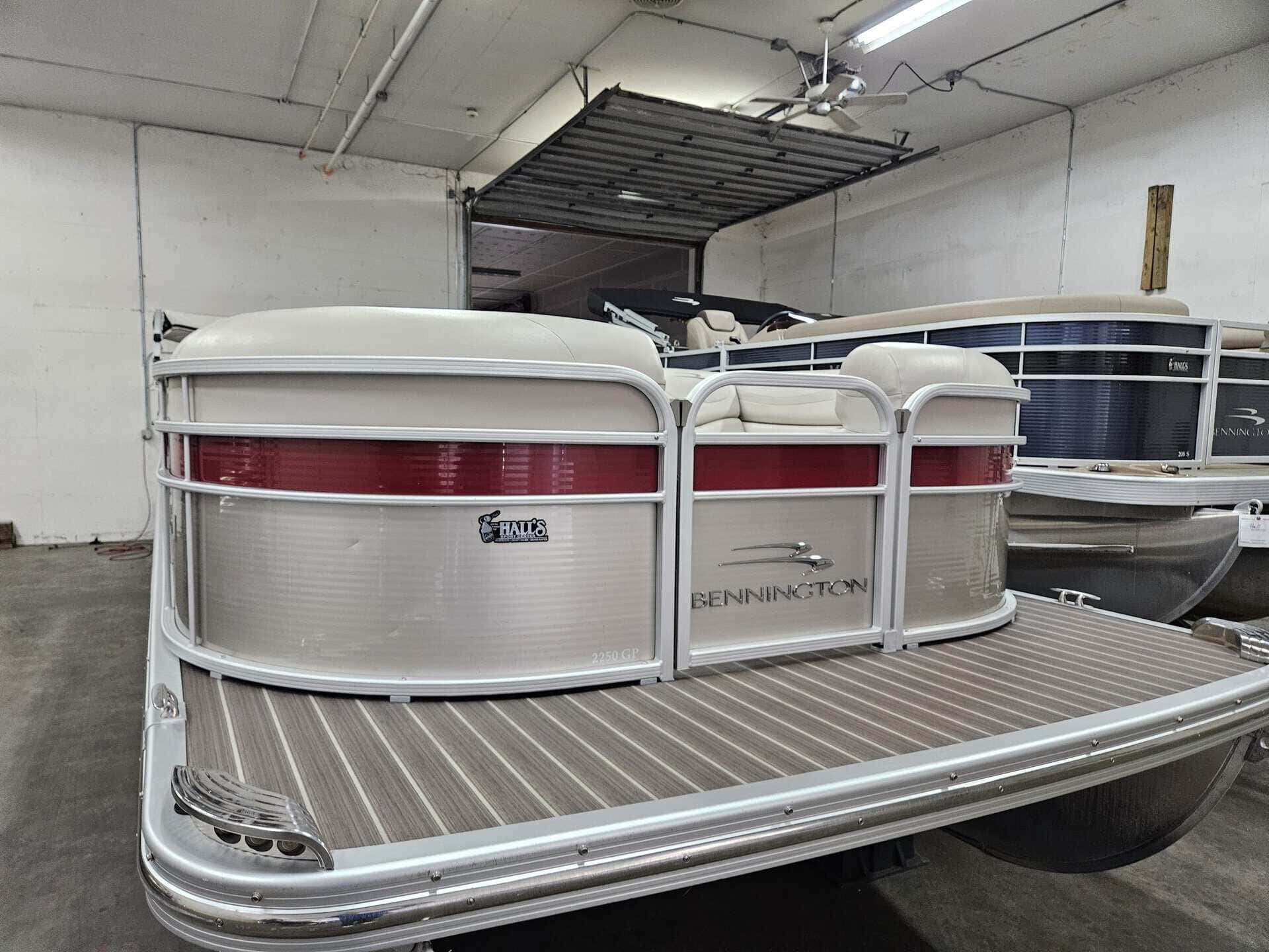 Bennington 2250 GPD pontoon boat in showroom at Hall's Sport Center.