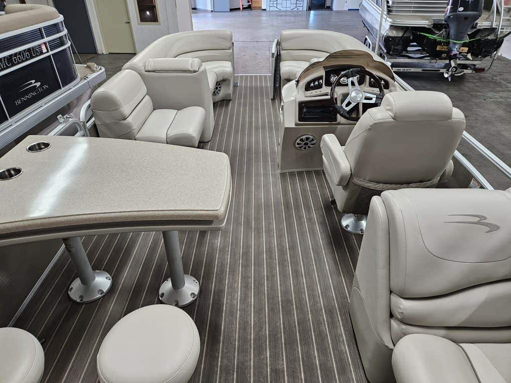 Bennington 2250 GPD pontoon boat interior with seating and steering wheel.