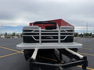 Bennington pontoon boat parked in lot at Hall's Sport Center.