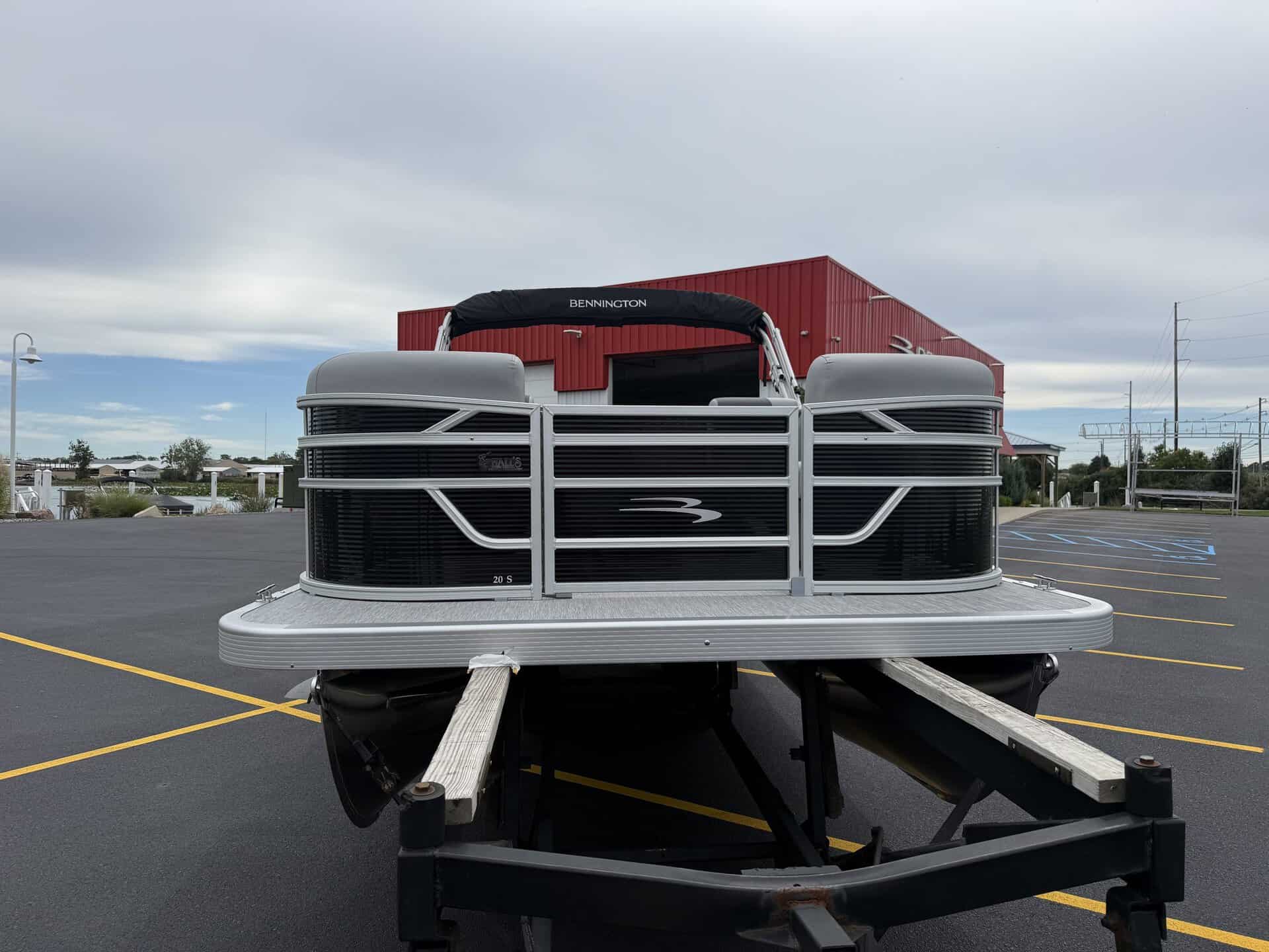 Bennington pontoon boat parked in lot at Hall's Sport Center.