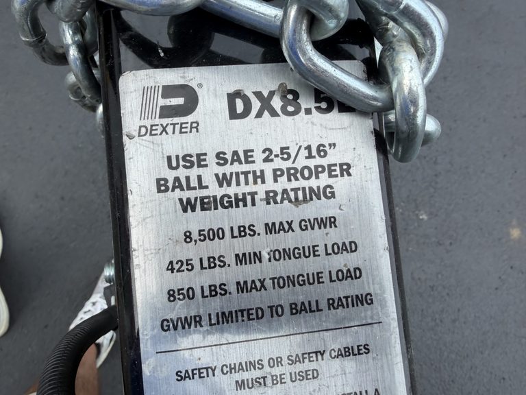 Trailer hitch chain with load capacity label for safety and proper use.