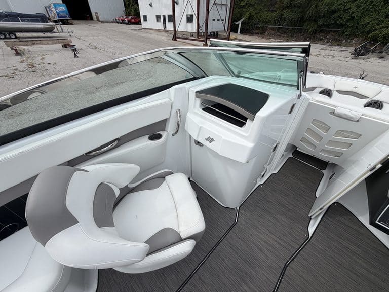Boat interior with steering and seating area for 2021 Four Winns H260.