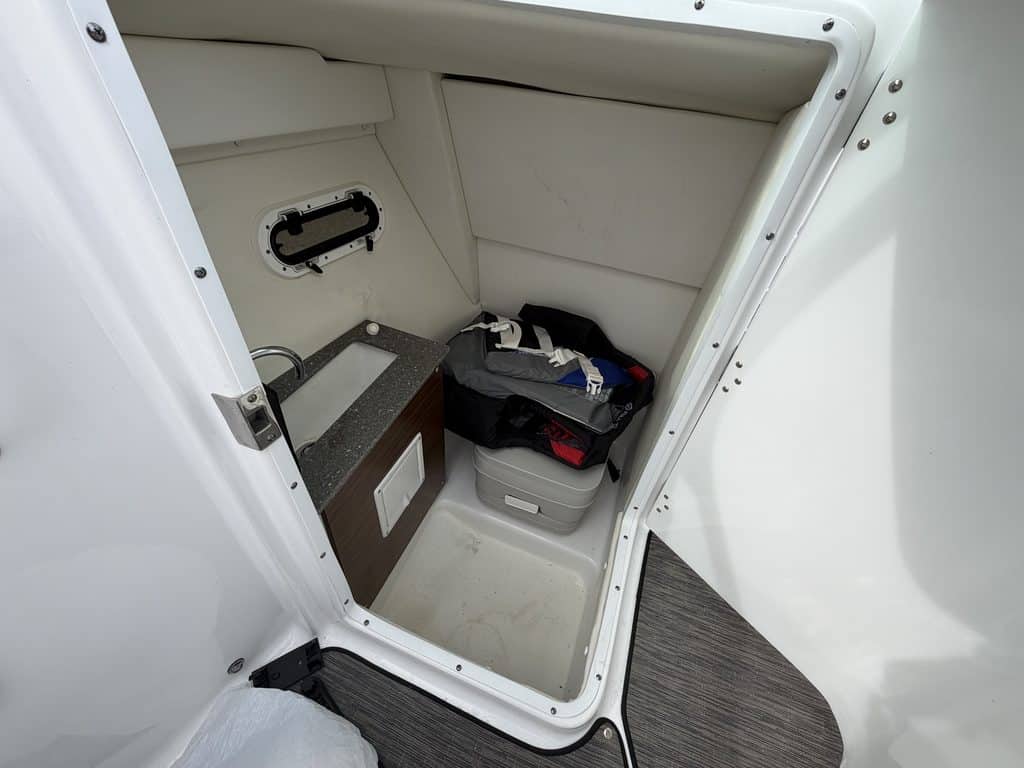 Boat storage compartment with tools and equipment at Hall's Sport Center.