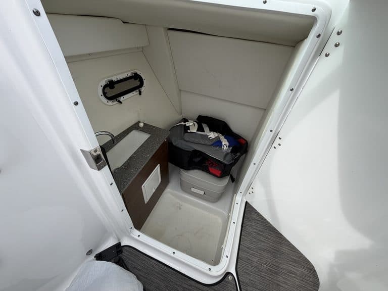 Boat storage compartment with tools and equipment at Hall's Sport Center.