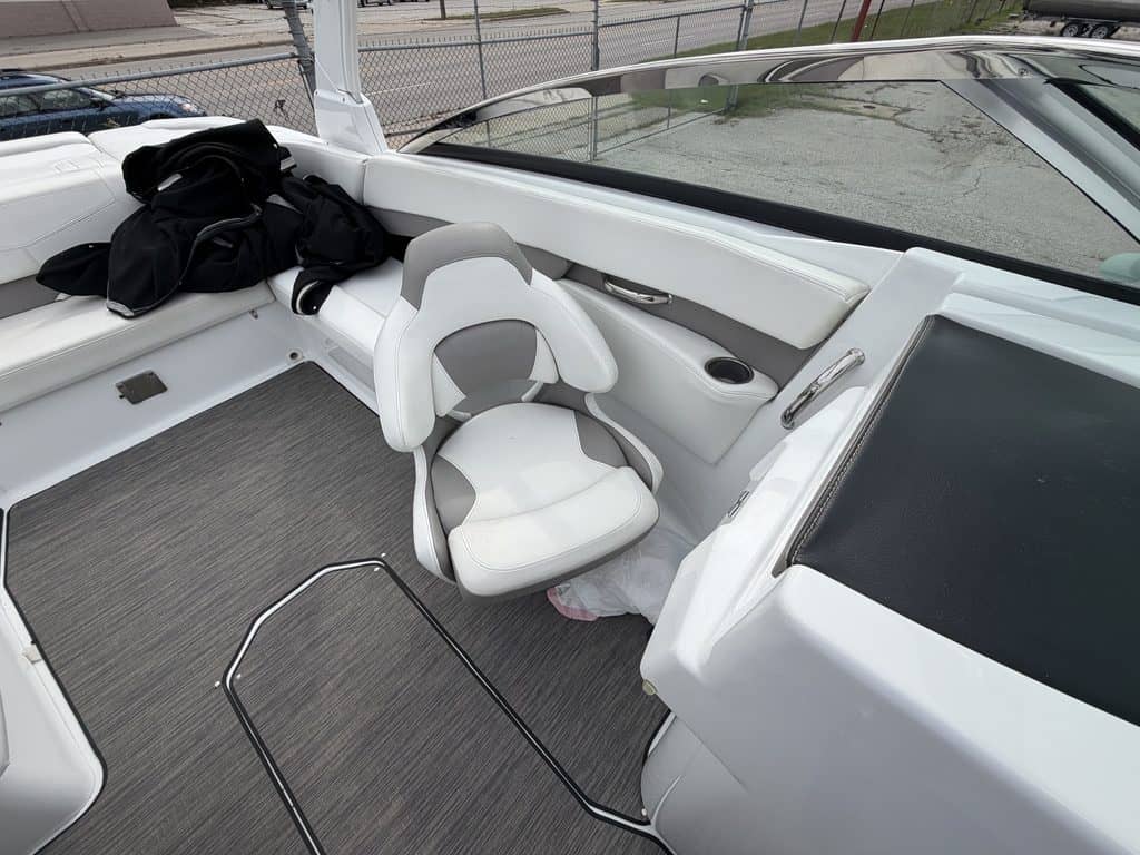Interior view of a Four Winns H260 boat with seating and steering area.