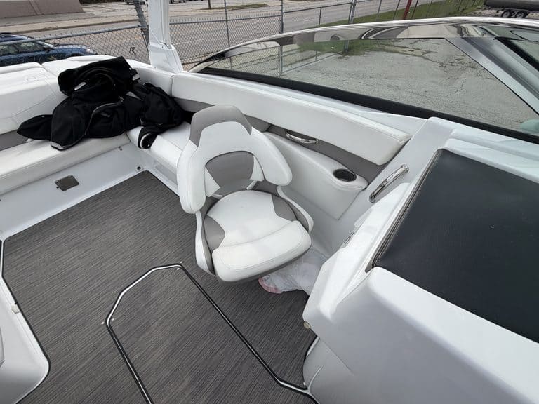 Interior view of a Four Winns H260 boat with seating and steering area.