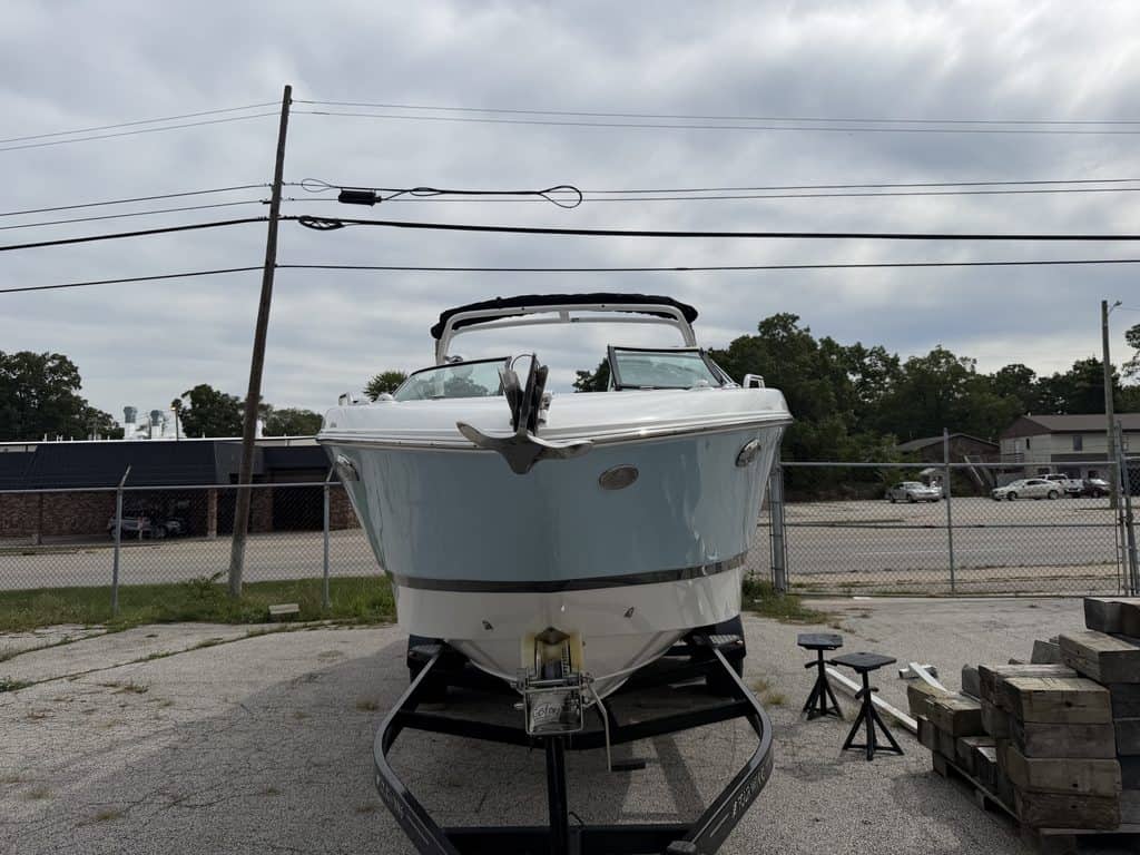 Blue and white Four Winns H260 boat on trailer at Hall's Sport Center.