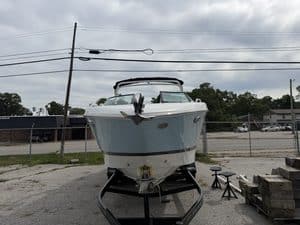Blue and white Four Winns H260 boat on trailer at Hall's Sport Center.
