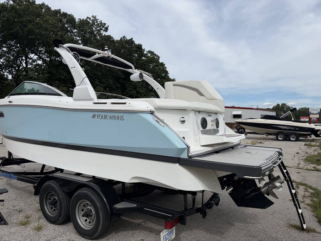 Luxury 2021 Four Winns H260 boat on trailer at marina.