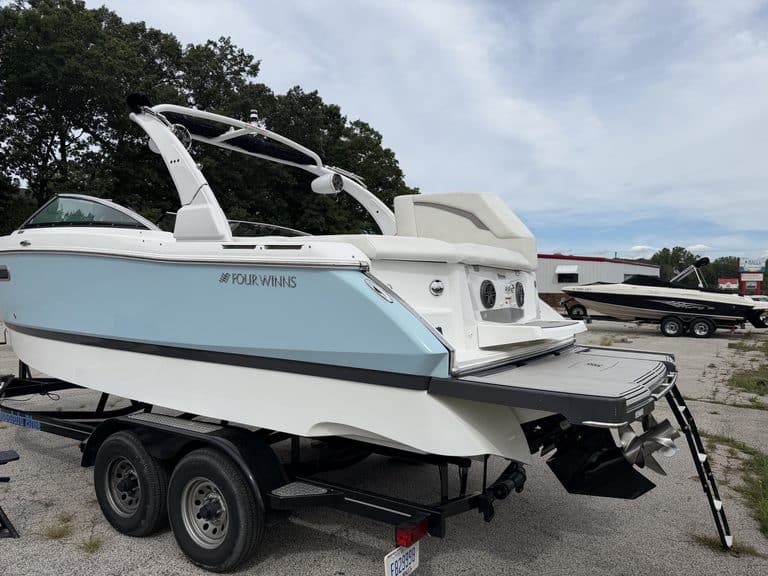 Luxury 2021 Four Winns H260 boat on trailer at marina.