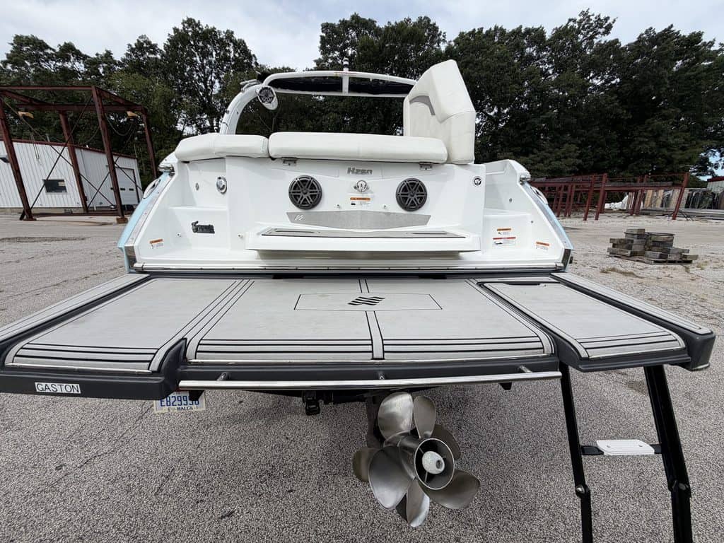 2021 Four Winns H260 boat on trailer with outboard motor.