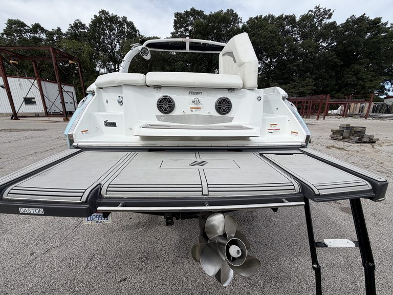 2021 Four Winns H260 boat on trailer with outboard motor.