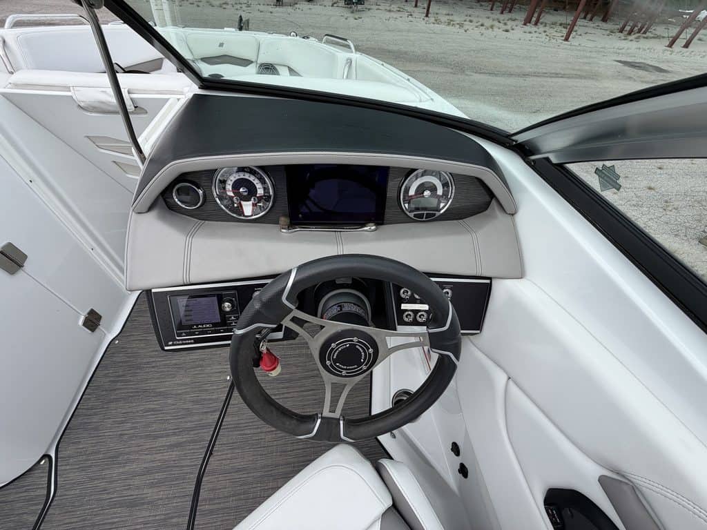 Interior view of the 2021 Four Winns H260 boat dashboard and steering wheel.