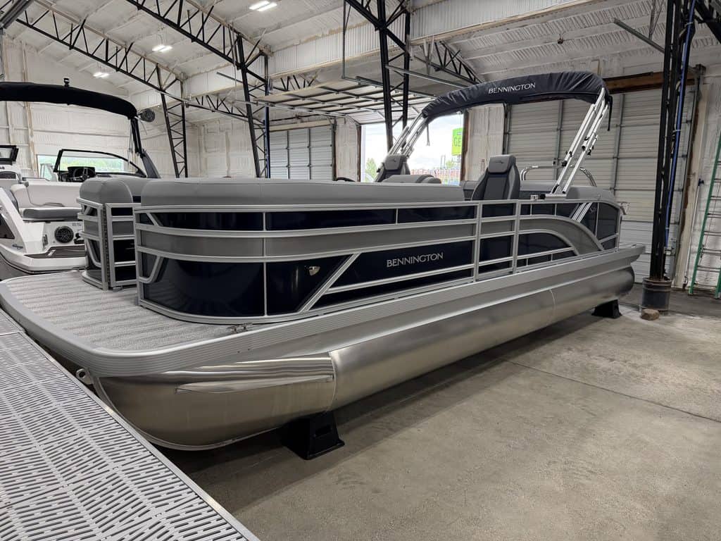 Bennington 23 SSB pontoon boat inside Hall's Sport Center.