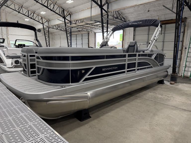 Bennington 23 SSB pontoon boat inside Hall's Sport Center.