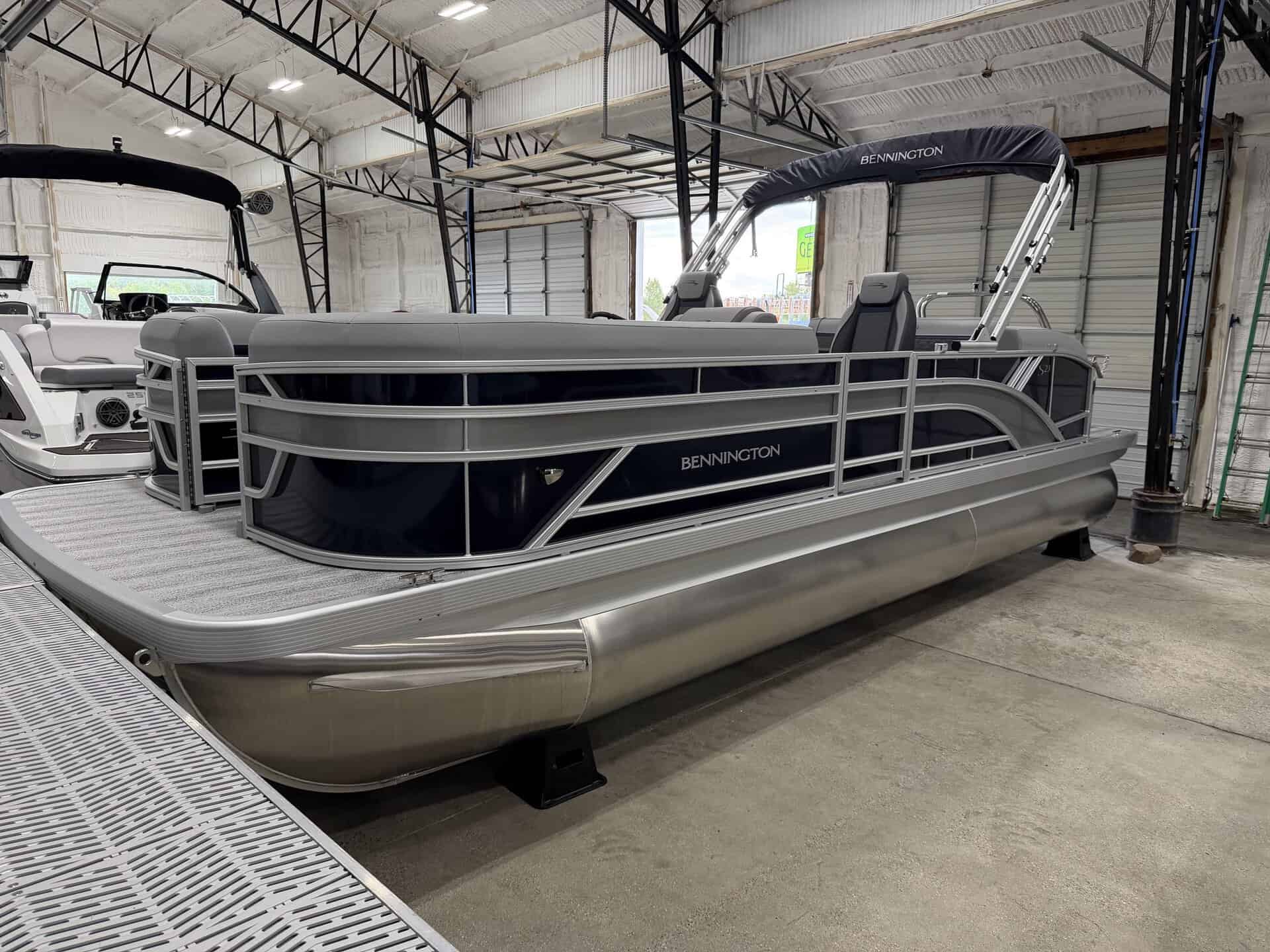 Bennington 23 SSB pontoon boat inside Hall's Sport Center.