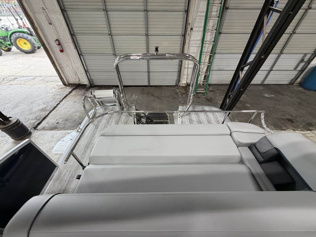 Bennington 23 SSB pontoon boat inside Hall's Sport Center.
